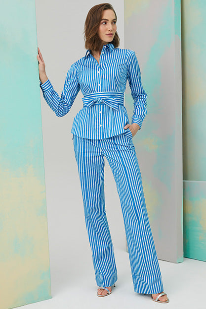 Lookbook photo of model wearing blue and white striped Tissot shirt and pants sets.