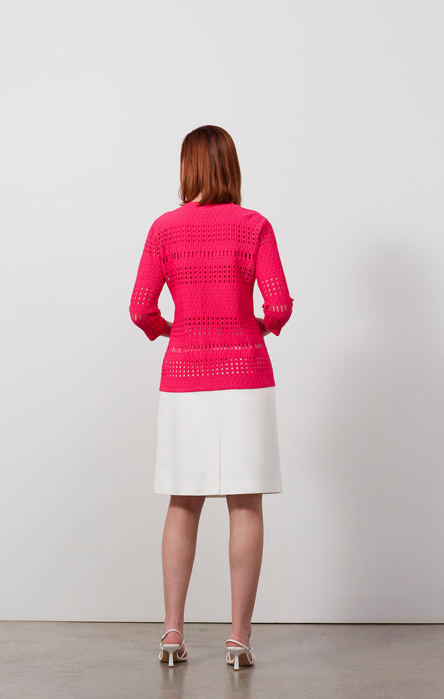 Ecomm photo of a model wearing the Blushing-Cardi, which is a airy ottoman and pointelle cardigan.