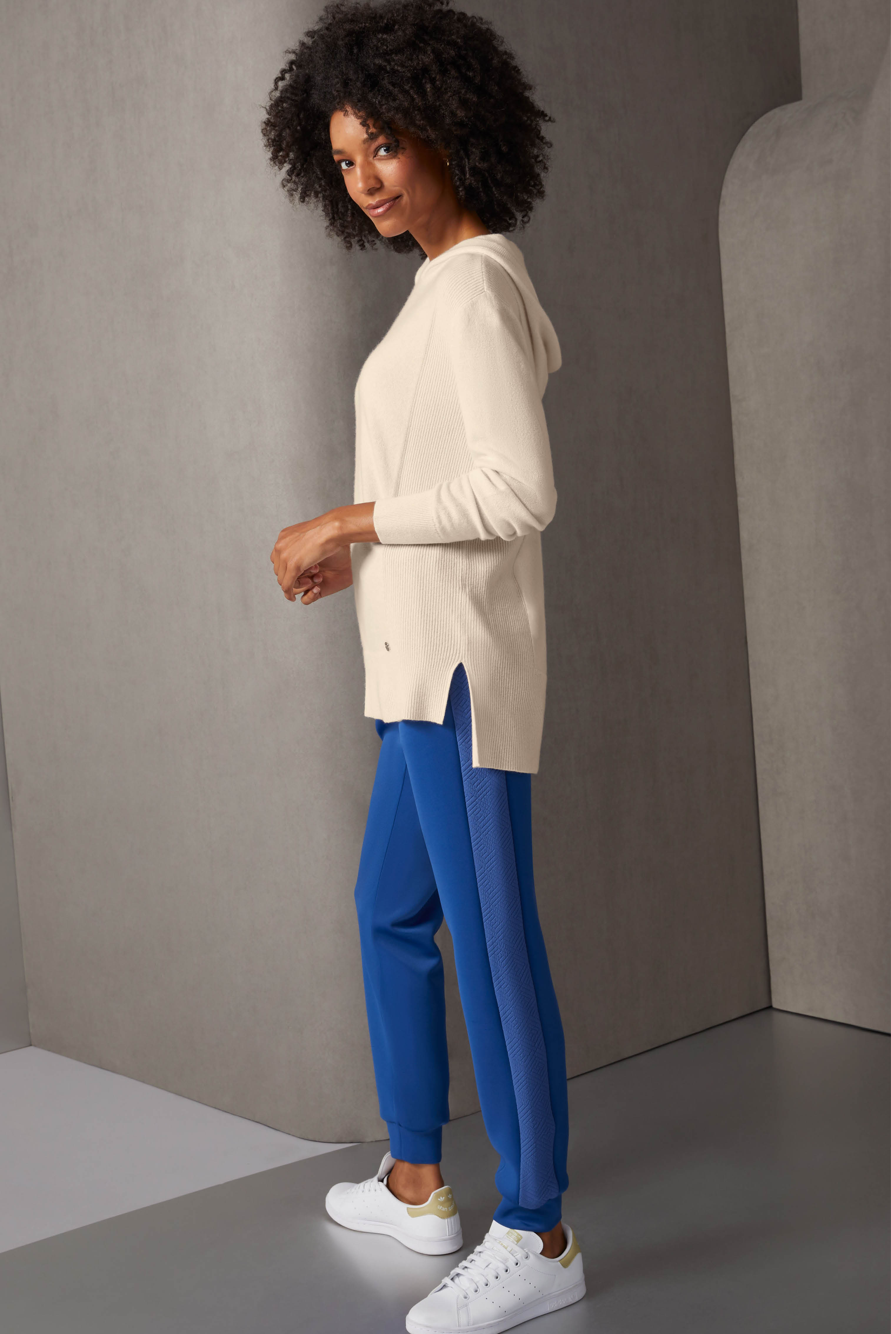 Contrast textures enrich this hoodie and jogger ensemble in creamy tapioca and bright nouvean navy. The high-low jersey hoodie is pure cashmere, with rib-knit accents at the sides, cuffs, and slit hem.