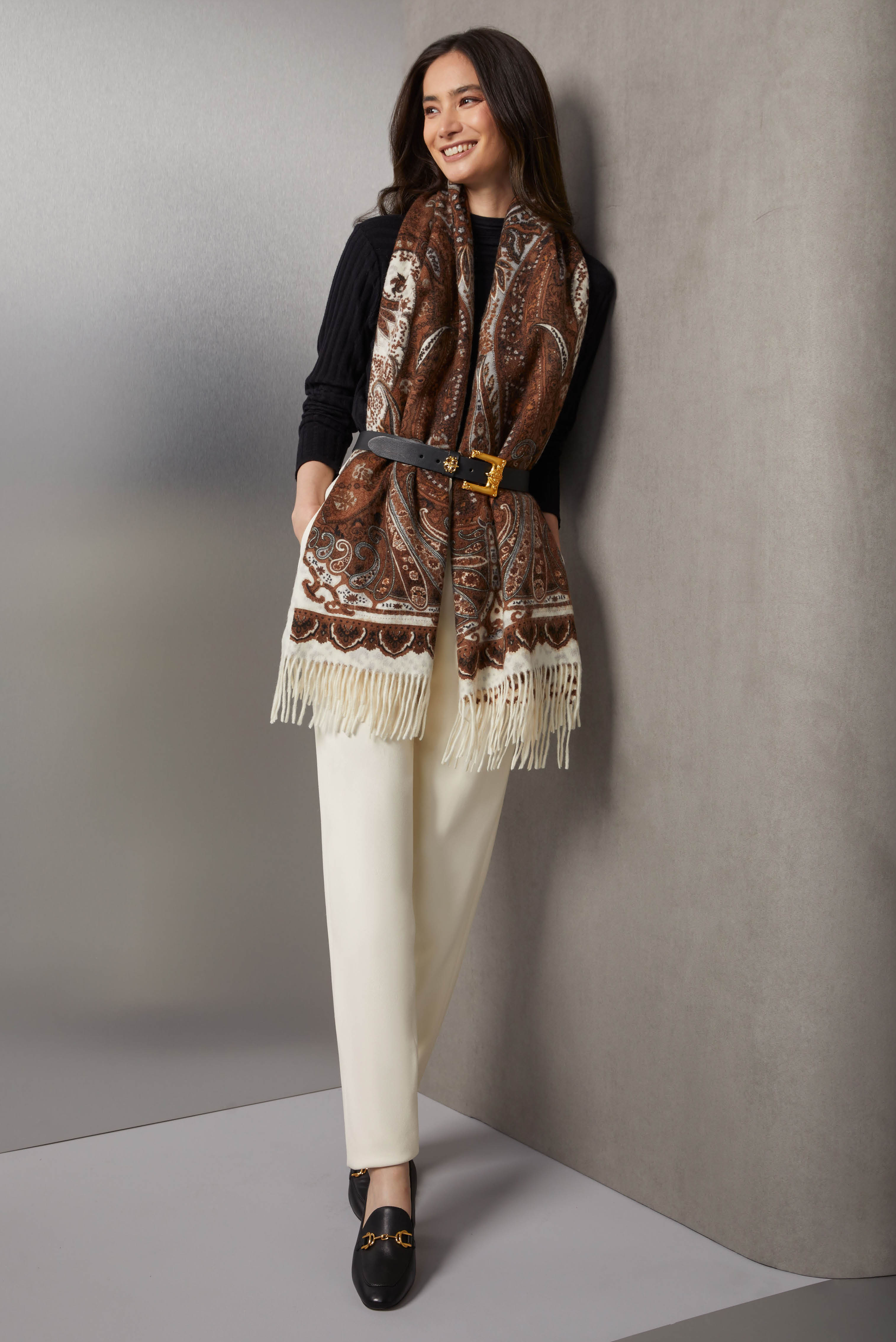 Layer a silk-enriched black mock turtleneck, textured with alternating jersey and half-cardigan ribs, over pleated pants in creamy tapioca white crêpe from Italy. The rococo belt in black leather is also from Italy.