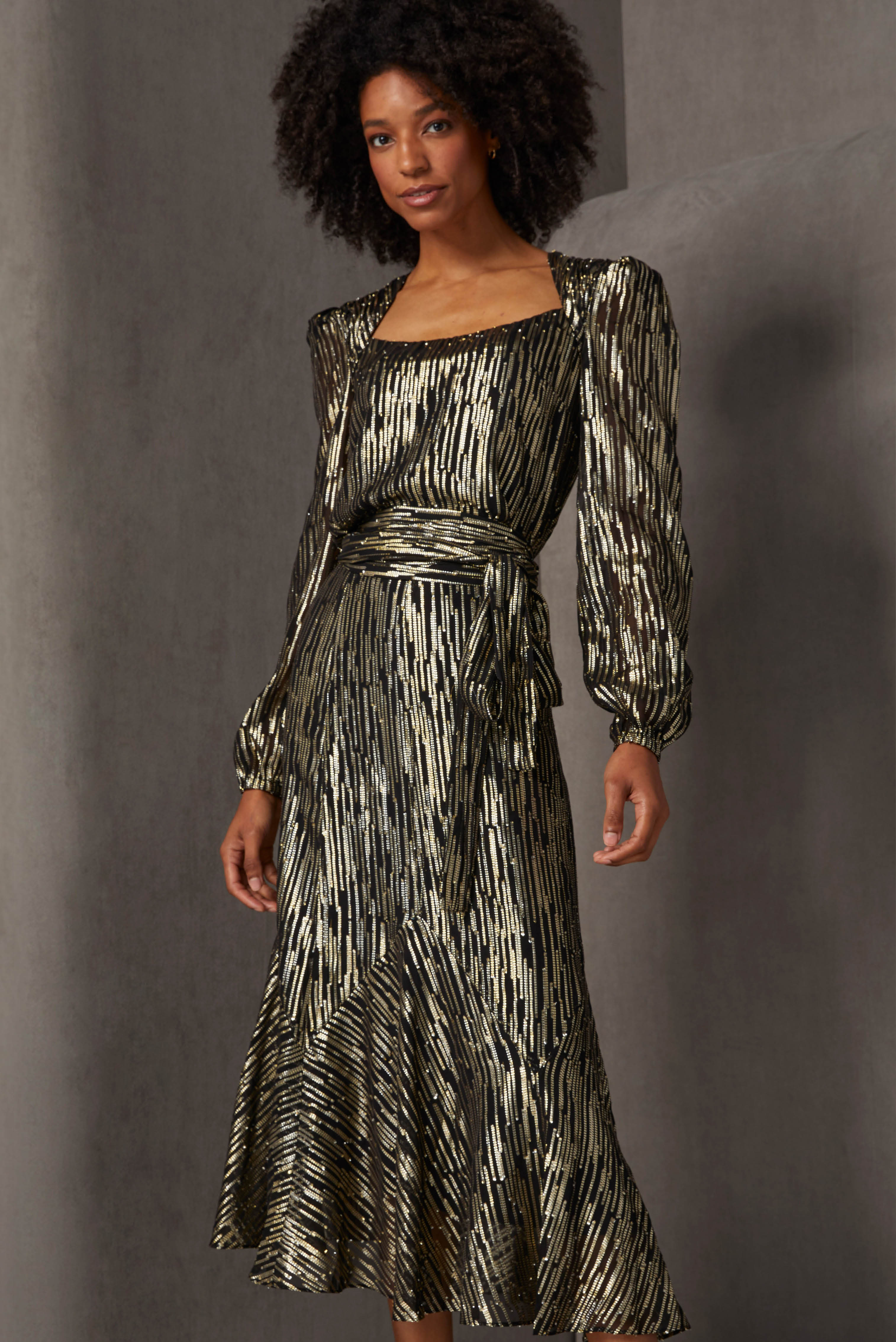 Enjoy a perfect fit for the top and skirt of this ensemble that looks like a belted evening gown. The silk-enriched fil coupé jacquard has a generous metallic gold component that takes the form of cascading stripes.