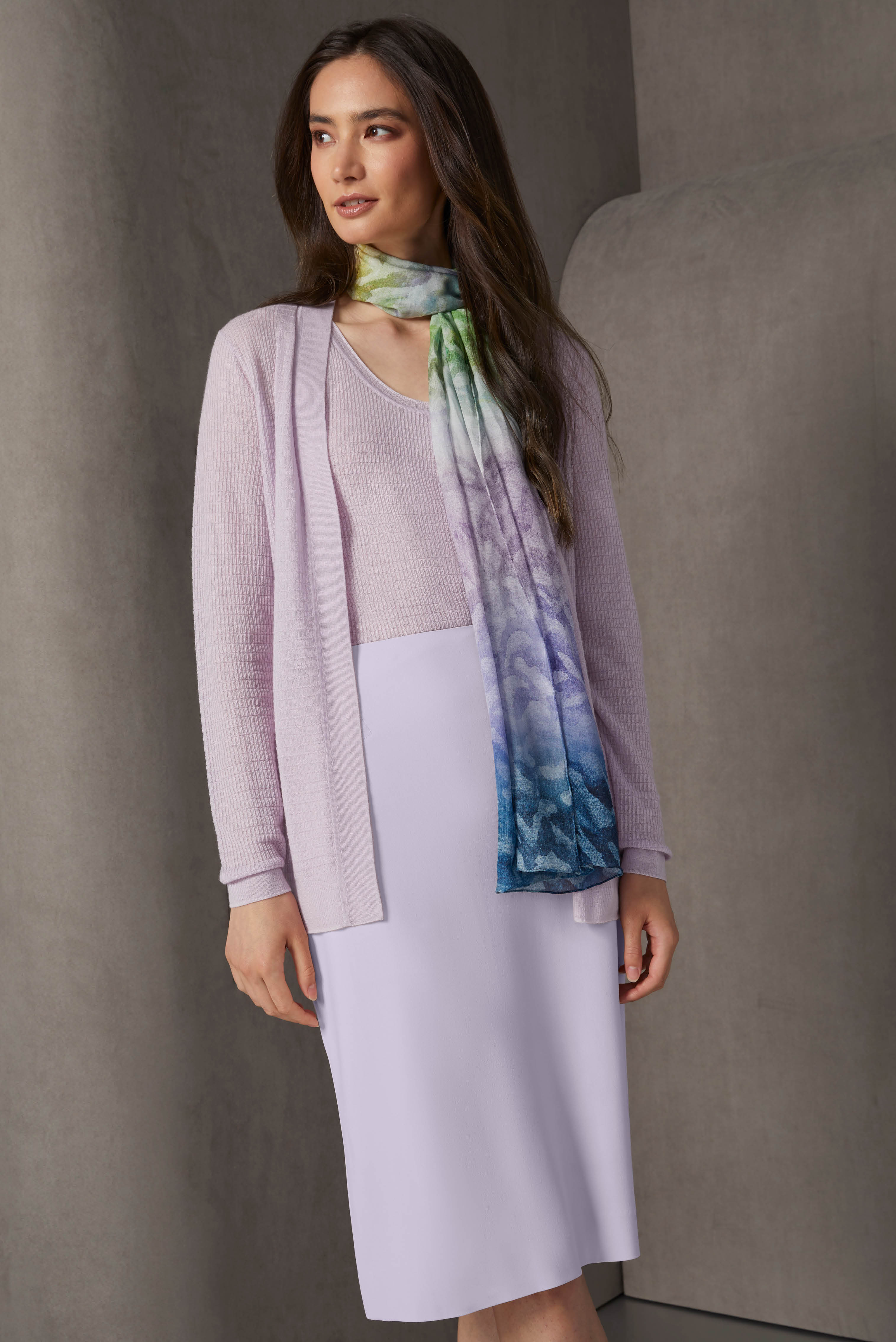 Dreamy lavender fog pieces excite the imagination. Anchoring the look is a silk-rich twill scarf in a twilight ombré landscape print that features painterly leaf shapes and contains the dominant tone of lavender.