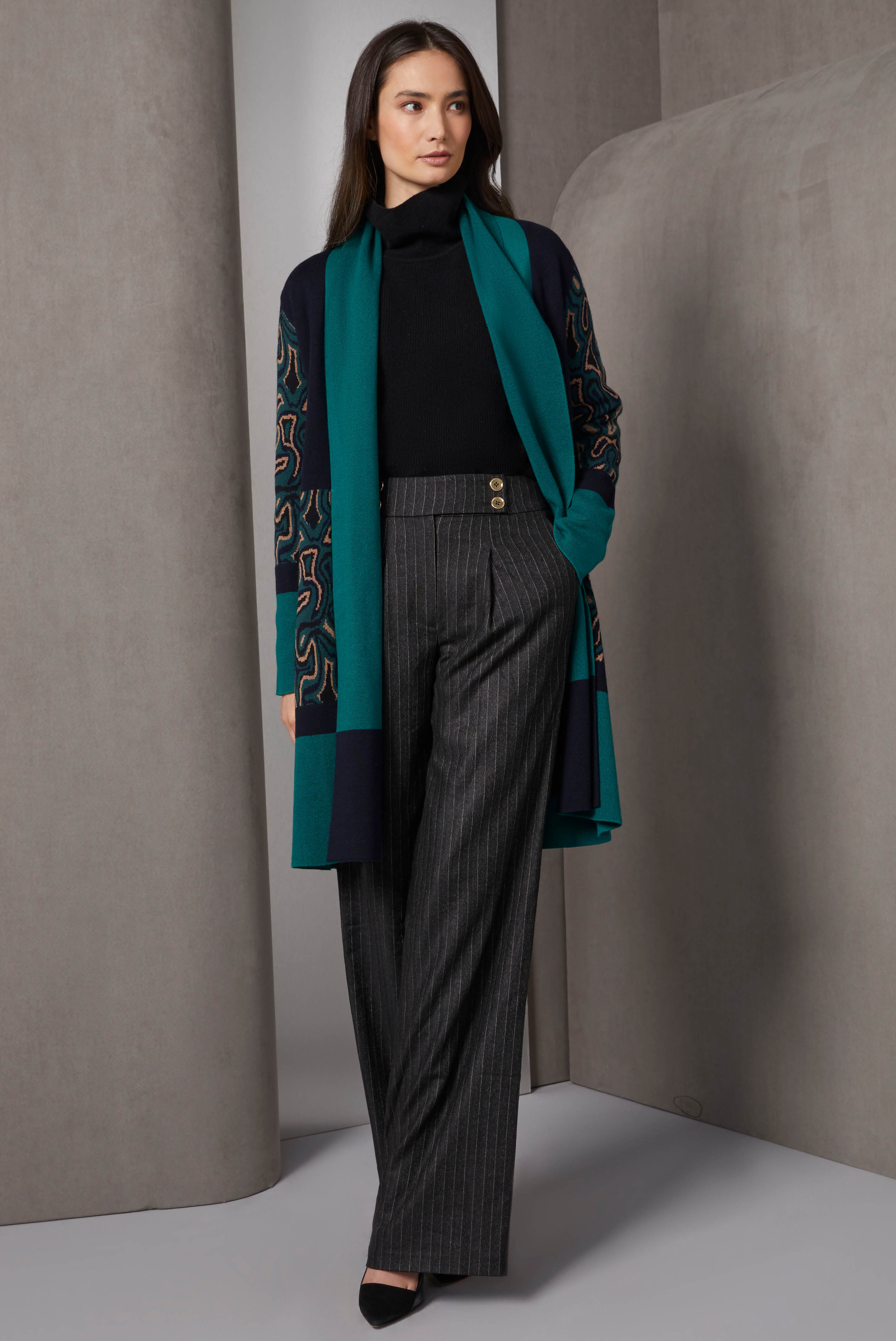 A cashmere-softened statement cardigan, ideal for special-occasions, combines solid green and black colorblock panels with panels in a complex, floral-look birdseye jacquard. 