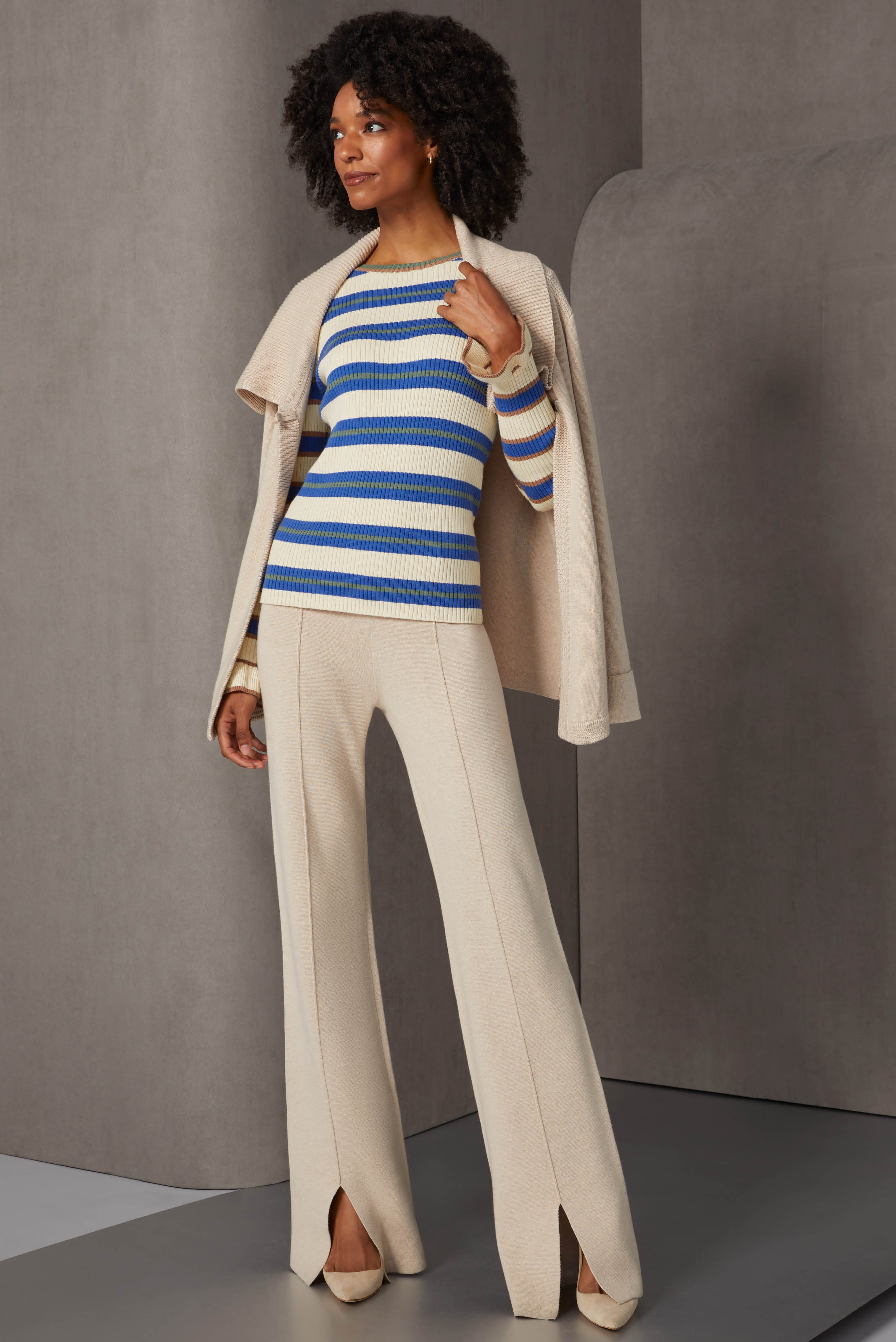 This cashmere-softened knit suit in creamy tapioca contrasts rib, jersey, and zig-zag stitches for rich texture. The jacket wing collar, as well as the slits and pintucks of these pants add opulent flair.