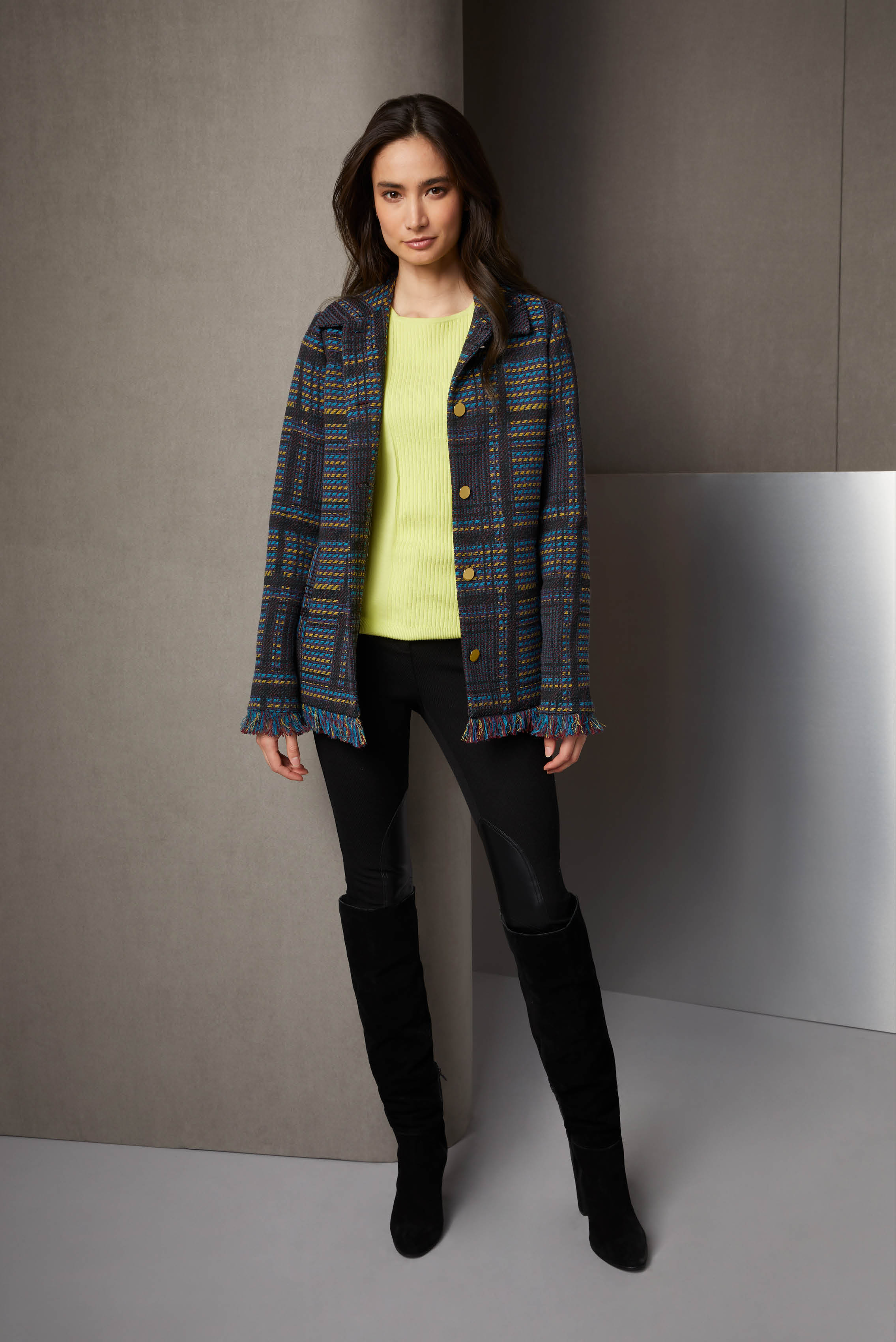 This sporty riding outfit is a nod to the Lenape people who named Manhattan. The woven plaid jacquard jacket has self fringe and a pioneer spirit. The black twill riding pants have European leather knee patches.