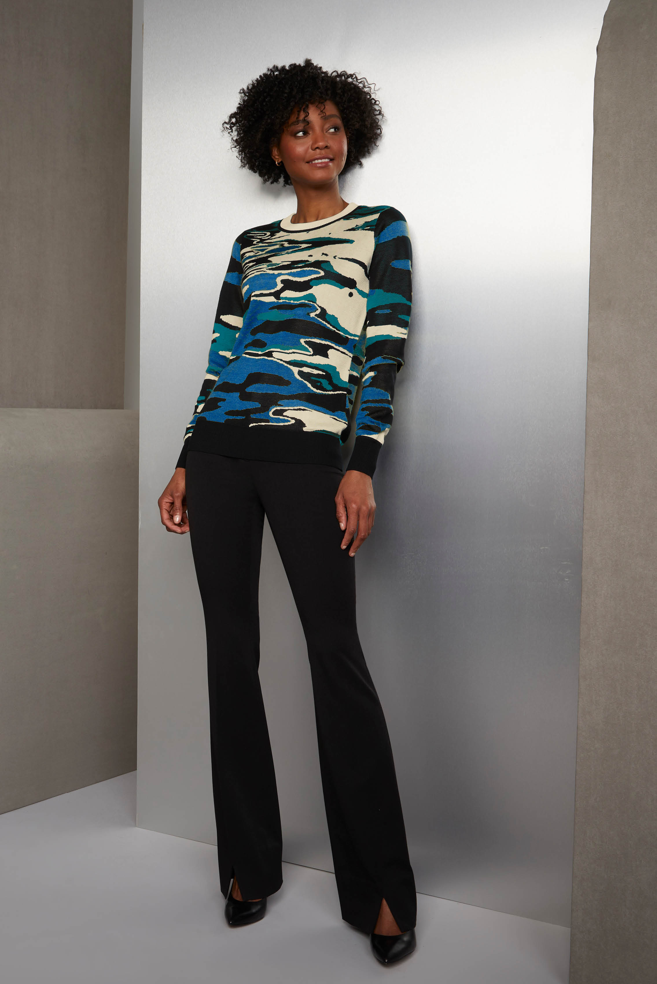 Captivating to the eye and sensual to the touch, this double-knit silk jacquard sweater creates a stunning illusion of light reflecting off the surface of a lake. The ribbed tapioca crew neck and the sleeves have black tipping.