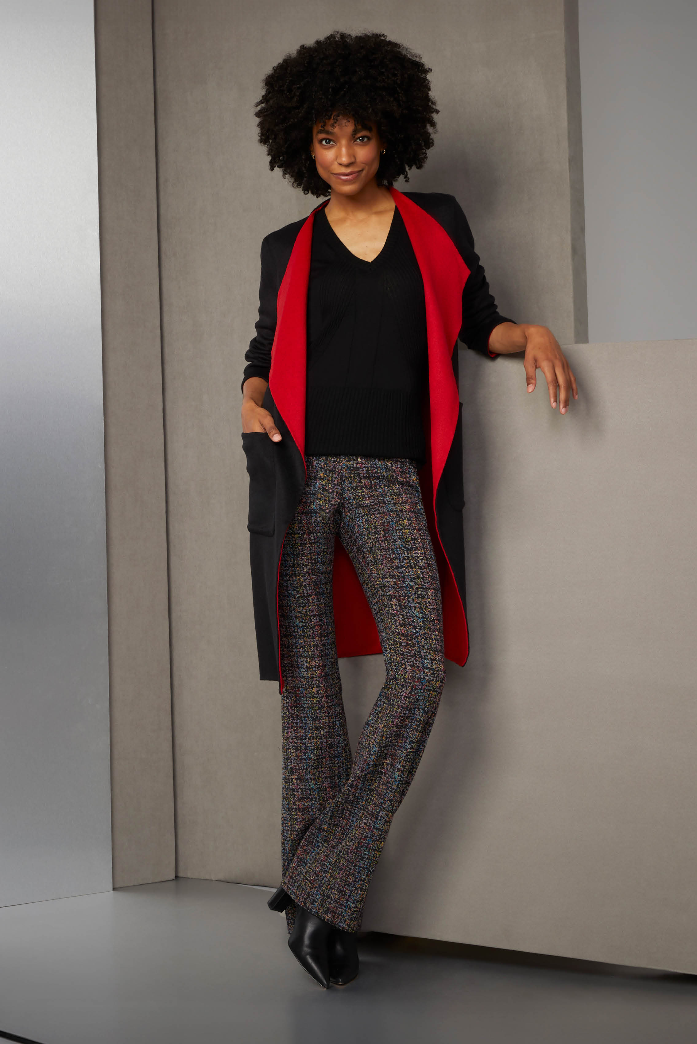 Harness color with chic details. The black Italian double-faced, wool-blend coat is accented with jester red, which pulls out the cabernet red and black of the radiant, eight-color Italian tweed pants.