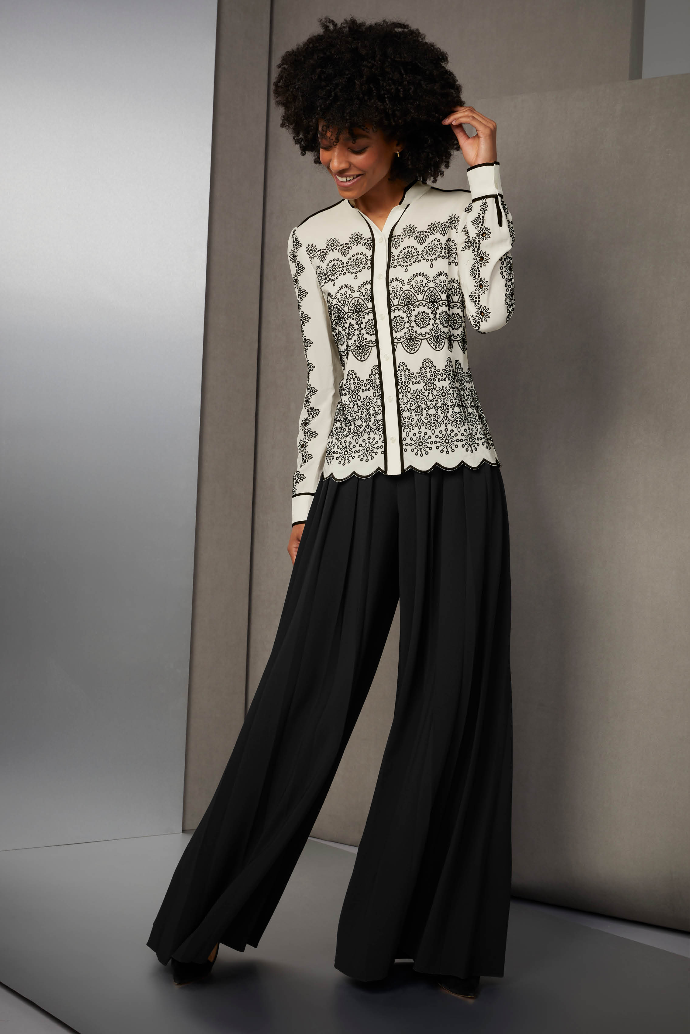 It may be simple black and white, but this blouse and pants duo is brimming with complex detail. Rows of black eyelet embroidery in nine patterns add endless visual fascination to the silk crêpe de chine blouse.