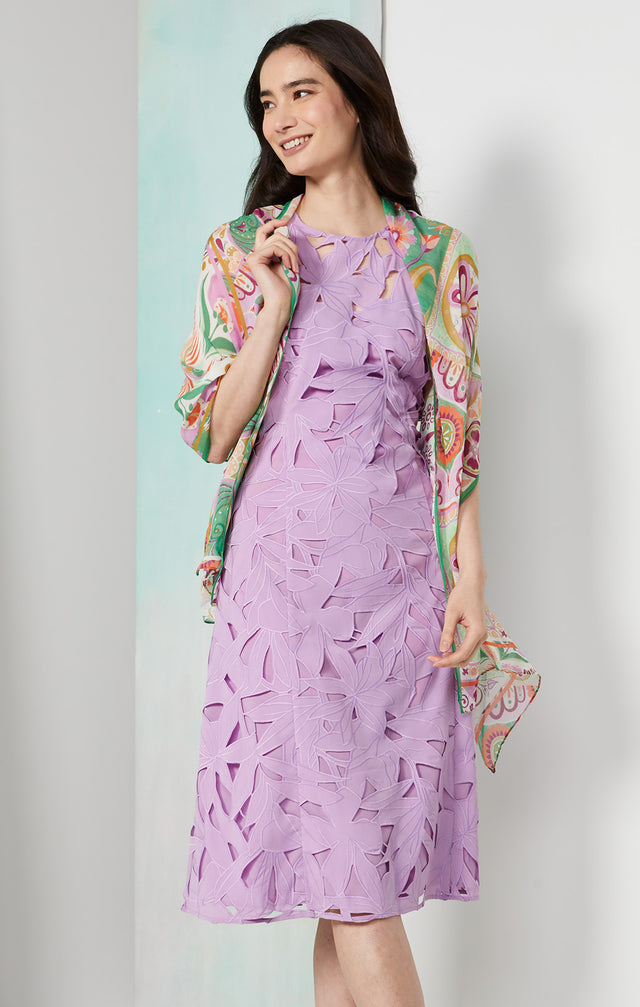 Lookbook photo of a model wearing the Solarium dress, which is an embroidered floral cutwork dress.