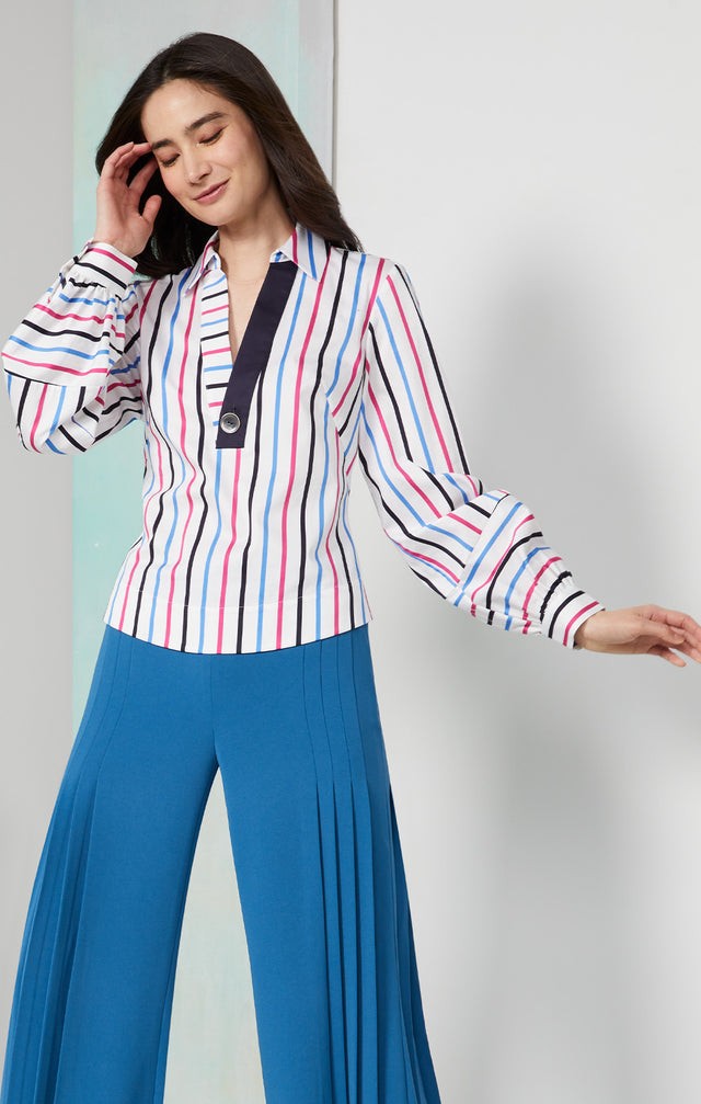 Lookbook photo of a model wearing the Ibiza shirt, which is a stripe print blouse in stretch cotton.