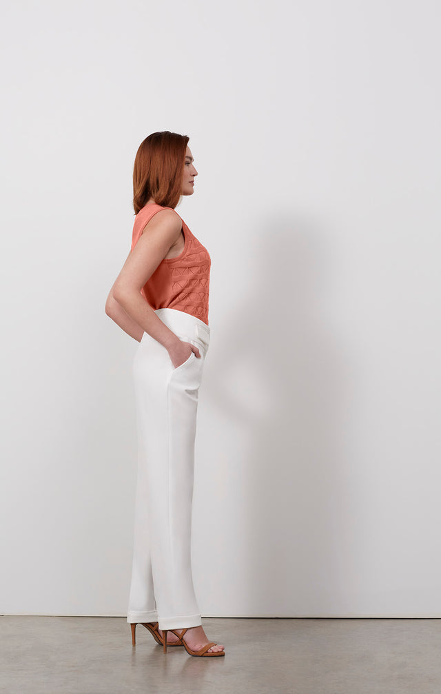 Ecomm photo of a model wearing the Finesse-Wht pants, which is a flap-pocket, double-weave pants.