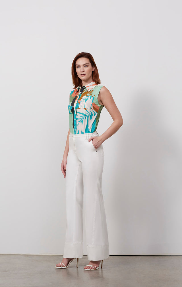Ecomm photo of a model wearing the Calatrava pants, which is a white stretch twill jeans.
