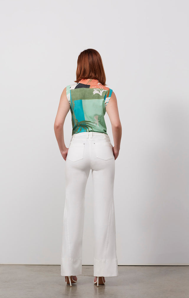 Ecomm photo of a model wearing the Calatrava pants, which is a white stretch twill jeans.