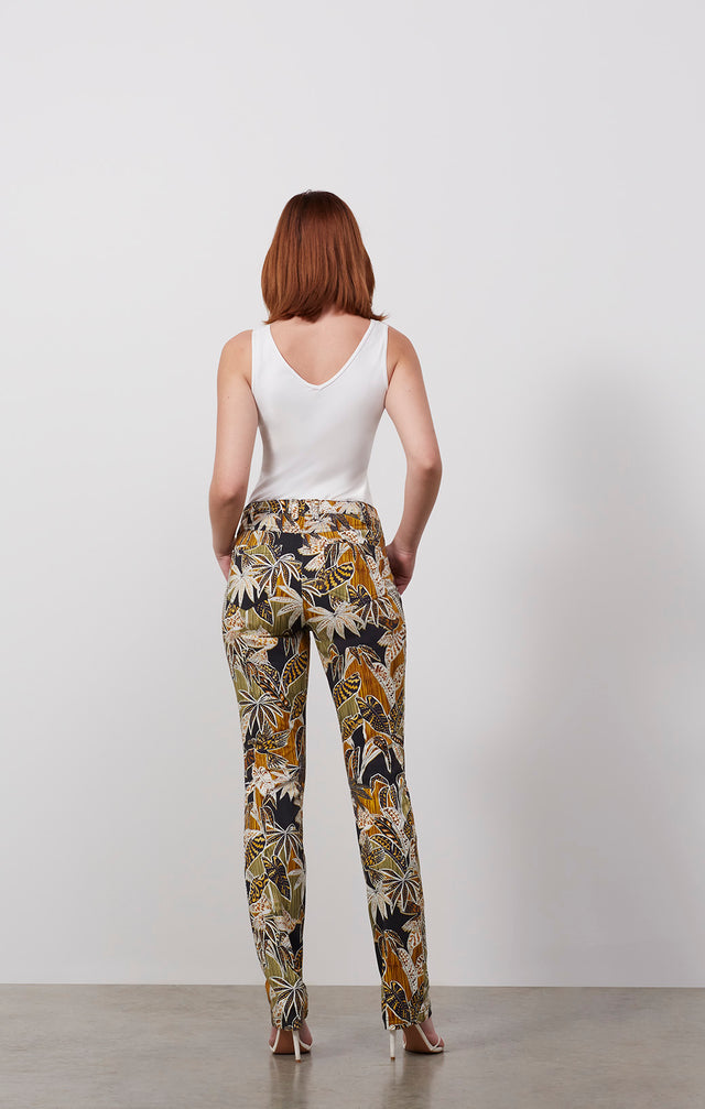 Ecomm photo of a model wearing the Inspiration pants, which is a tropical print jeans.