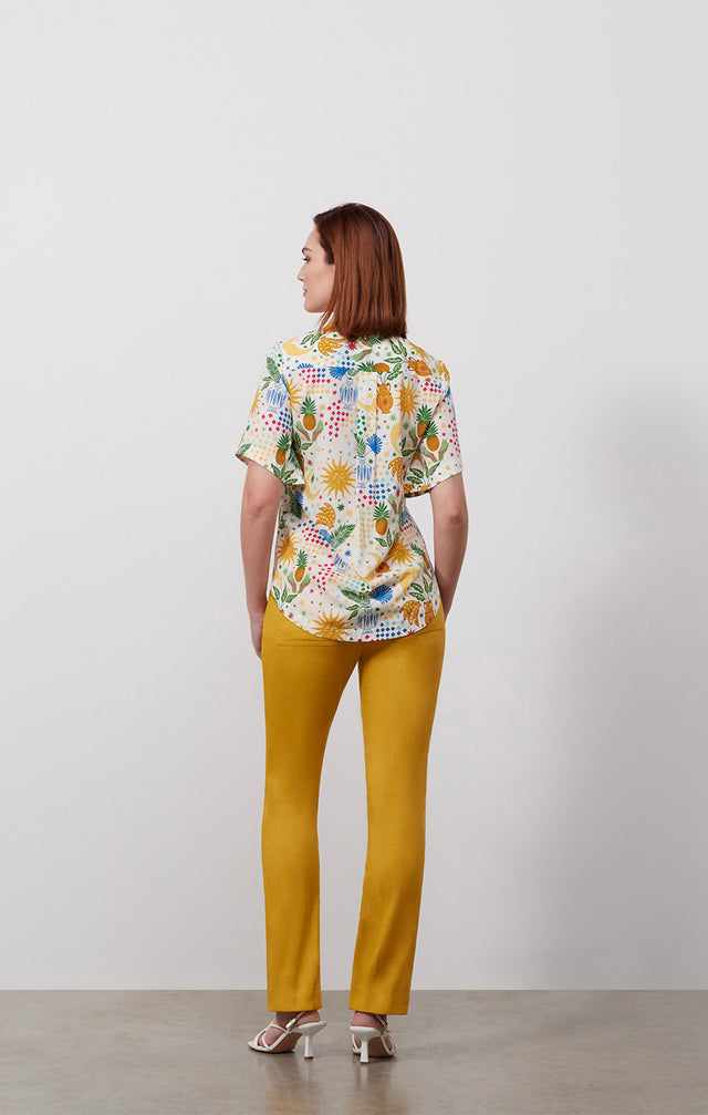 Ecomm photo of a model wearing the Beaming shirt, which is a stretch silk crêpe print blouse.