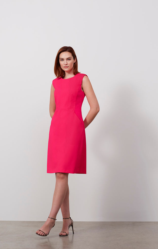Ecomm photo of a model wearing the Rambutan dress, which is an Italian stretch jacquard dress.