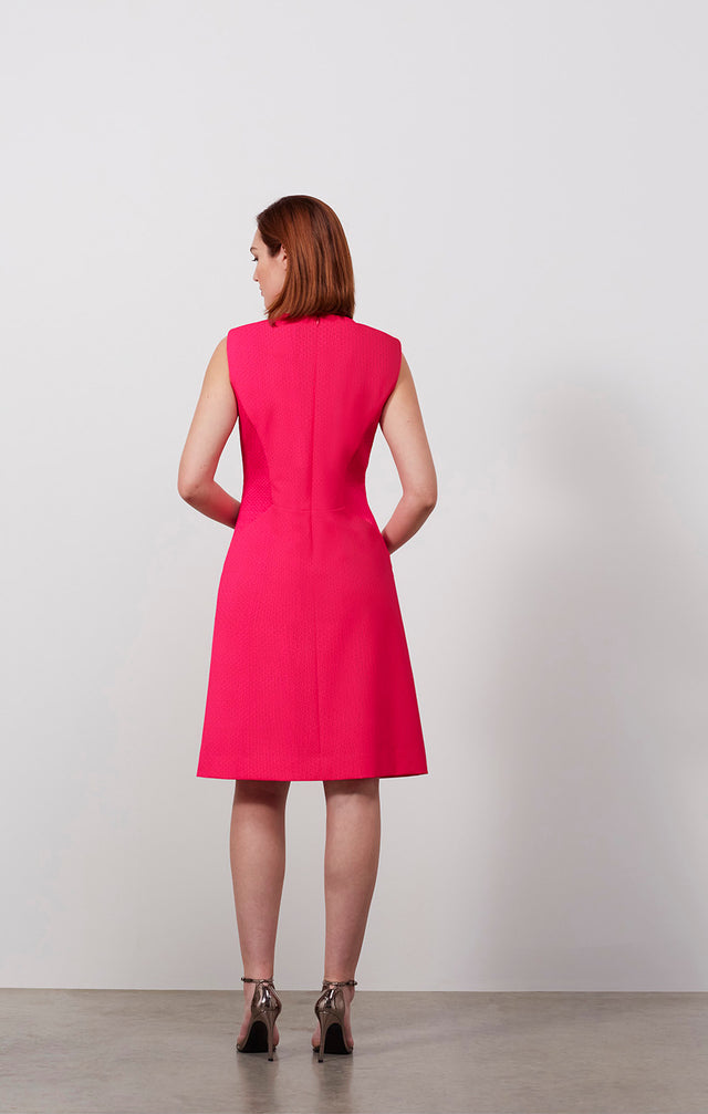 Ecomm photo of a model wearing the Rambutan dress, which is an Italian stretch jacquard dress.