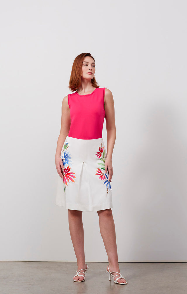 Ecomm photo of a model wearing the Iberia skirt, which is an embroidered white cotton sateen skirt.