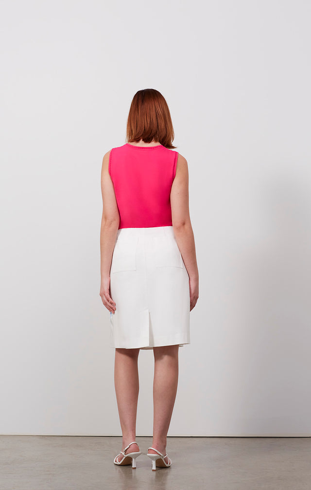 Ecomm photo of a model wearing the Iberia skirt, which is an embroidered white cotton sateen skirt.