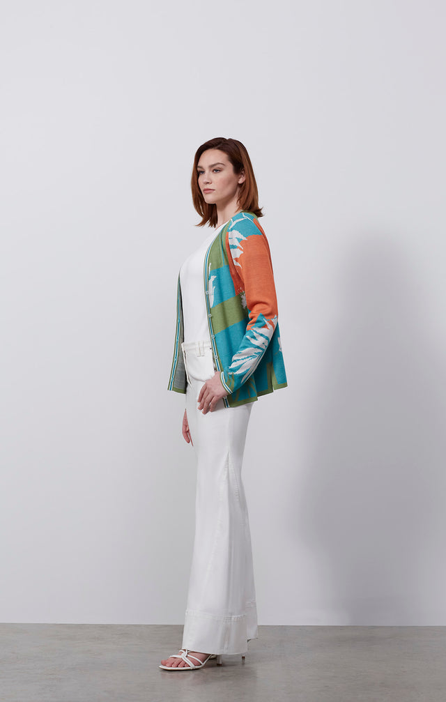 Ecomm photo of a model wearing the Paradise sweater, which is a tropical birdseye jacquard knit cardigan .