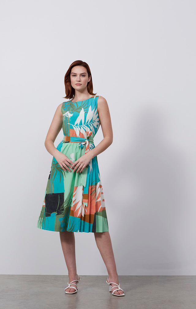 Ecomm photo of a model wearing the Jardiniere dress, which is a tropical-print, stretch silk pleated dress.