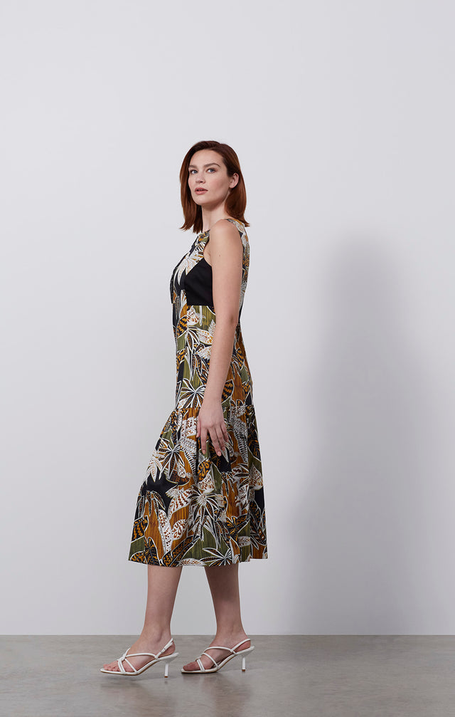 Ecomm photo of a model wearing the Picasso dress, which is a silk-rich tropical print dress.