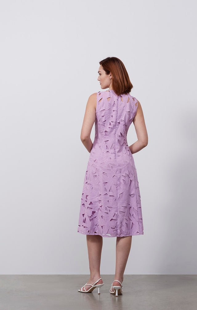 Ecomm photo of a model wearing the Solarium dress, which is an embroidered floral cutwork dress.
