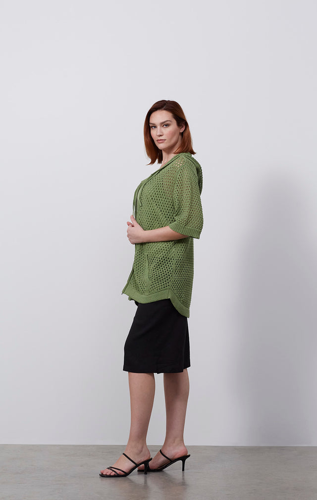 Ecomm photo of a model wearing the Verdure sweater, which is a linen-blend knit hoodie.
