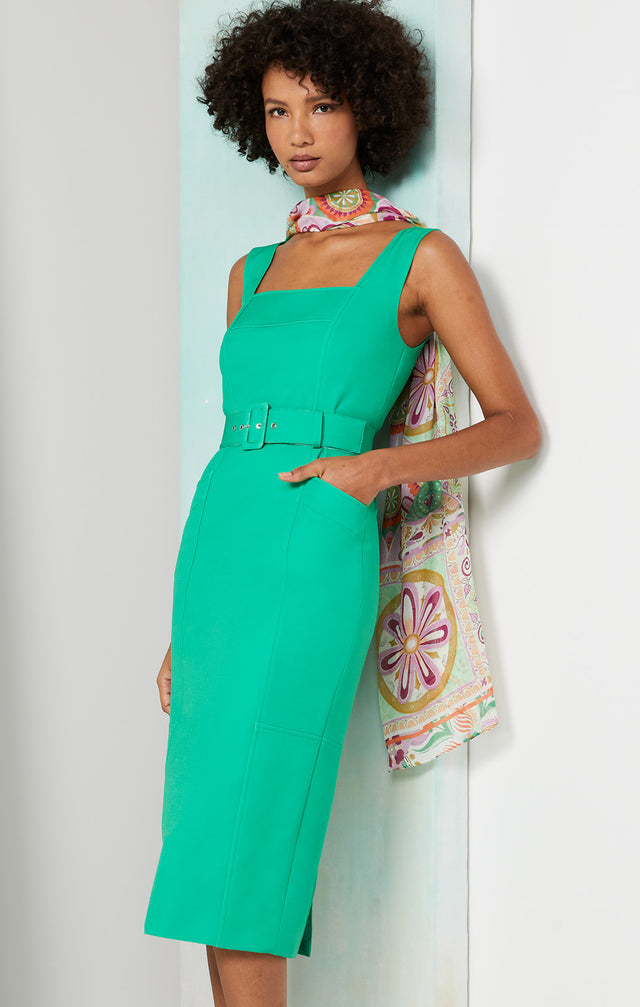 Lookbook photo of a model wearing the Esmeralda dress, which is a belted dress in stretch double weave.