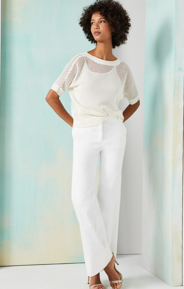 Lookbook photo of a model wearing the Balance-Wht shirt, which is a organic cotton reversible knit top with cami.